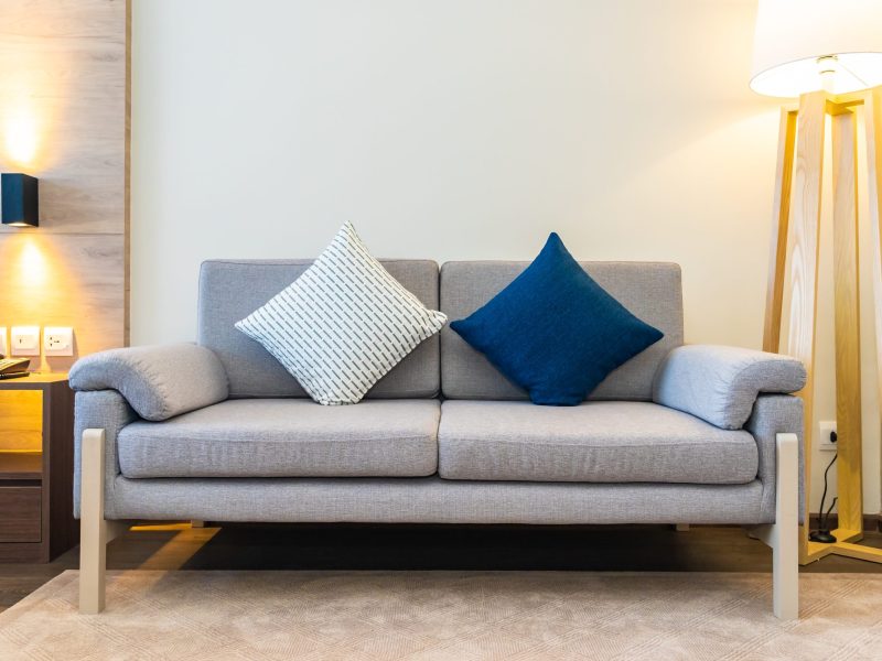Comfortable pillow on sofa decoration with light lamp interior of living room area